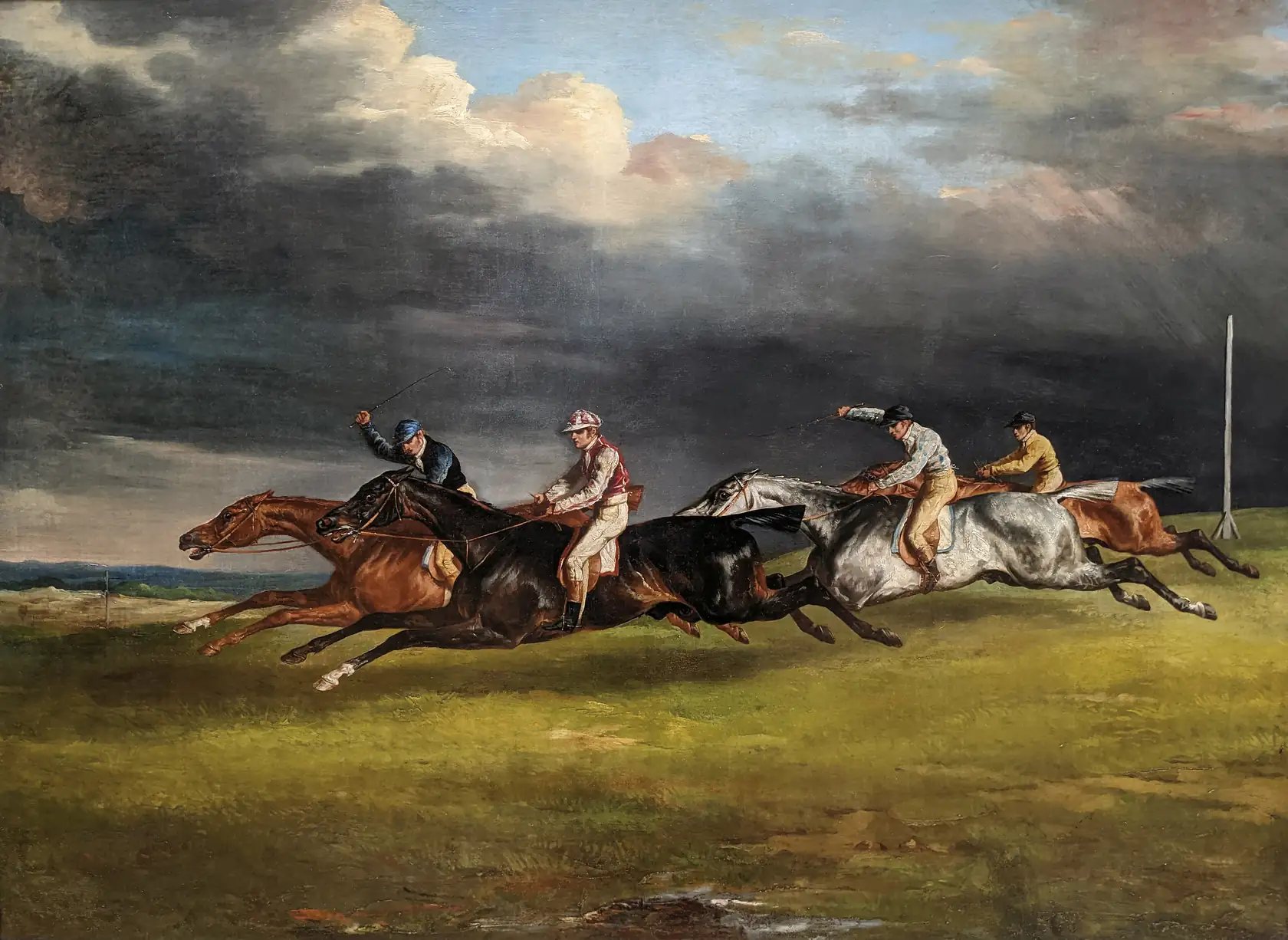 Jockeys racing horses at full gallop